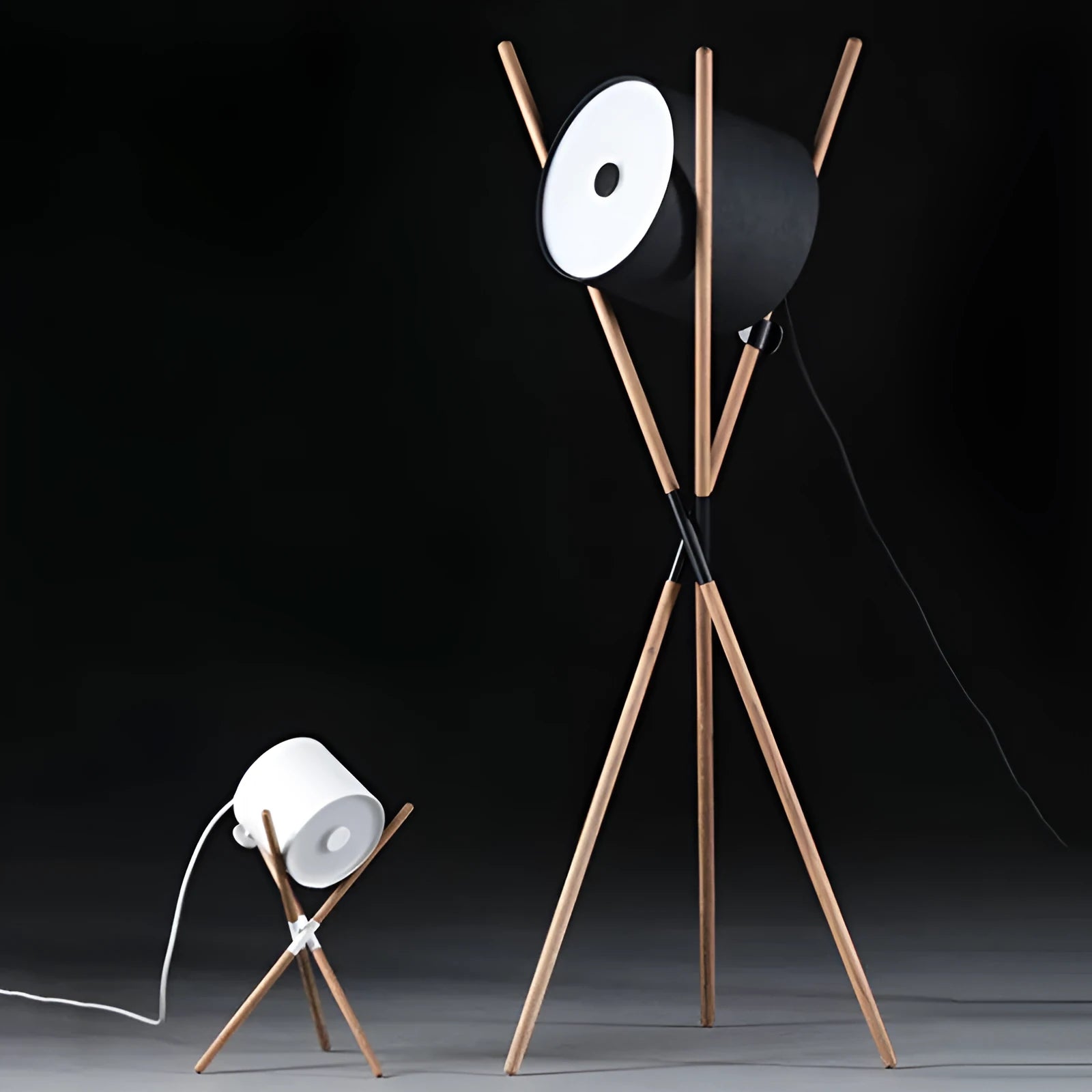 Modern three fork floor lamp with wood body and white acrylic shade on a wooden floor.