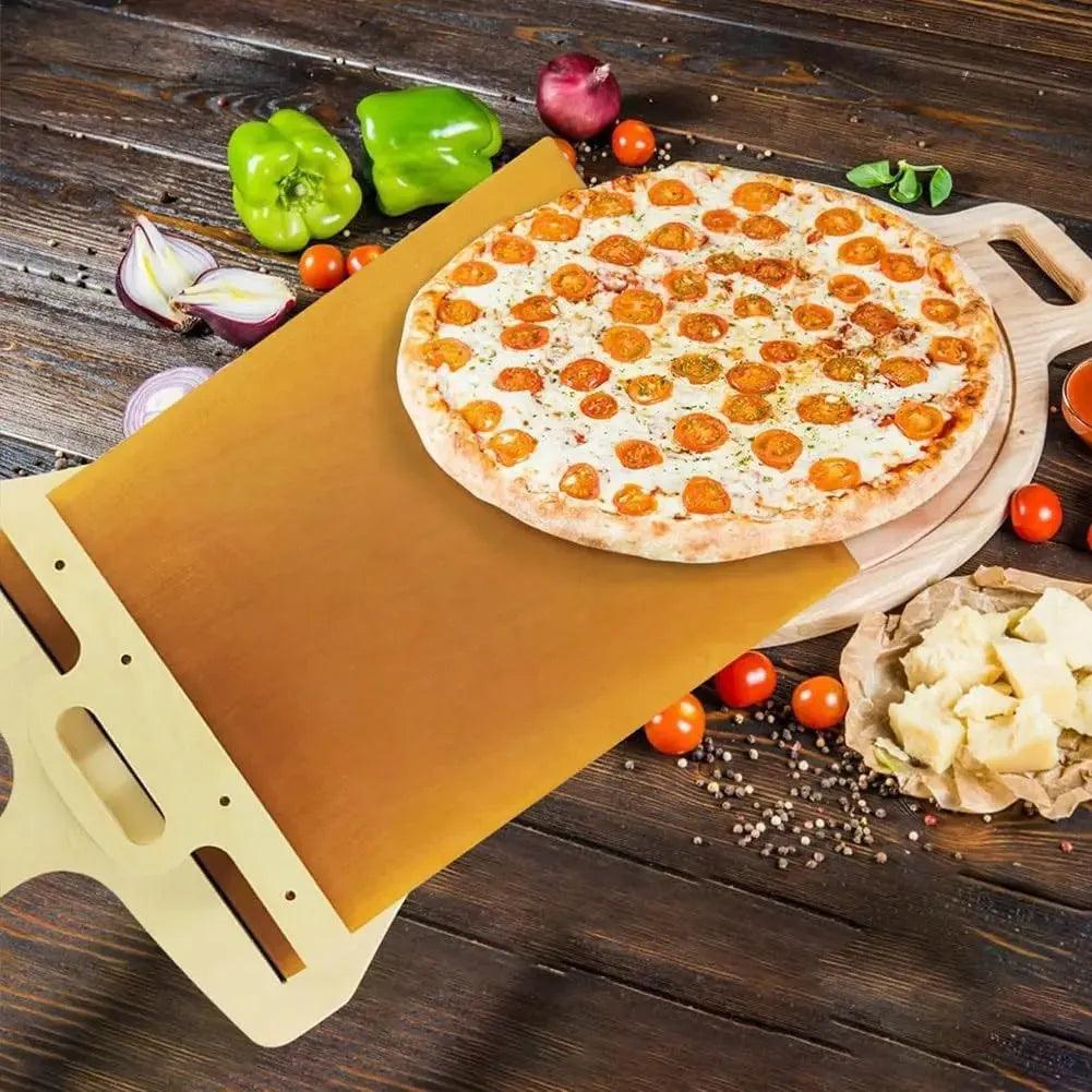 White plastic pizza transfer shovel with handle and hanging hole on a kitchen counter.