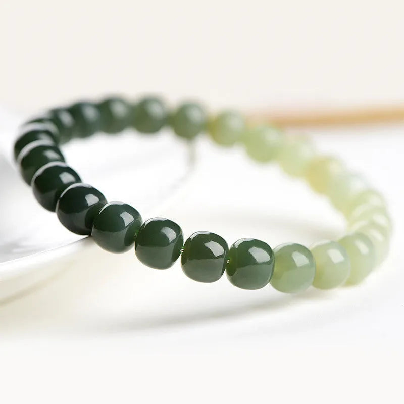 Natural Hetian jade bracelet with gradient clear water colours showing polished beads