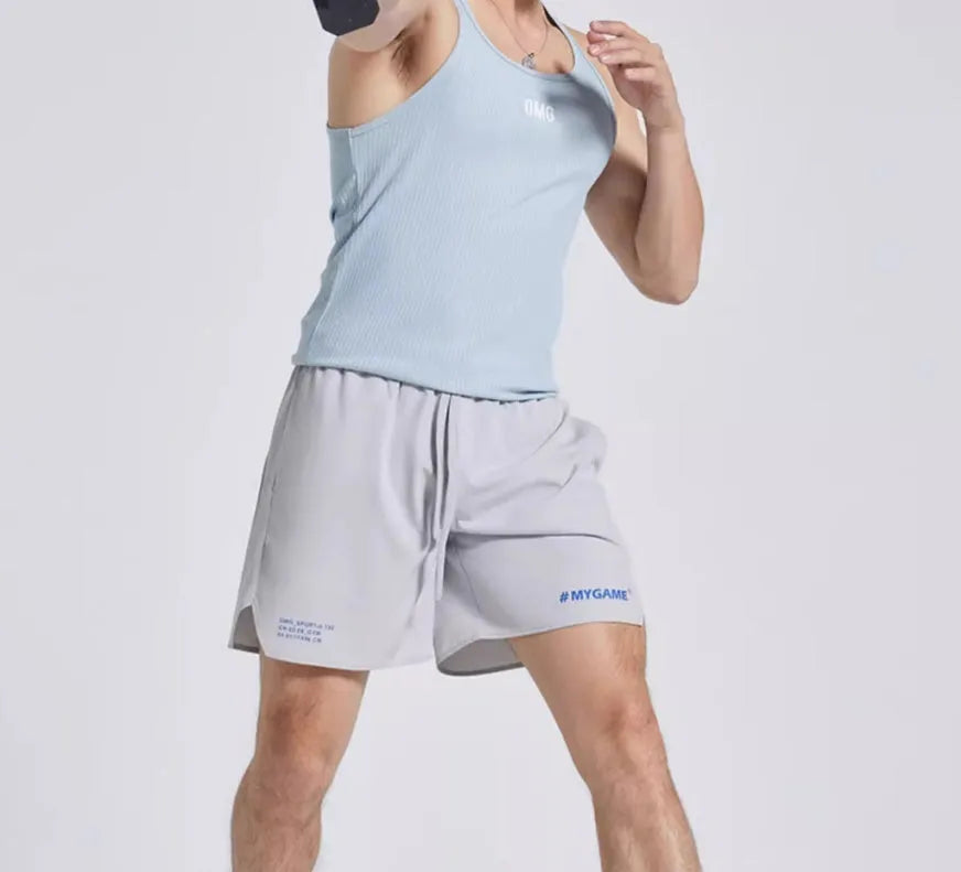 Men's midnight blue training fitness shorts with moisture-wicking fabric on a gym background.