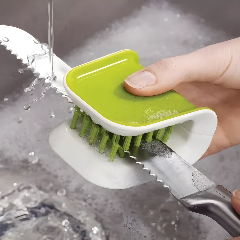 Blue U-shaped plastic brush for cleaning kitchen knives and cutlery on a kitchen counter.