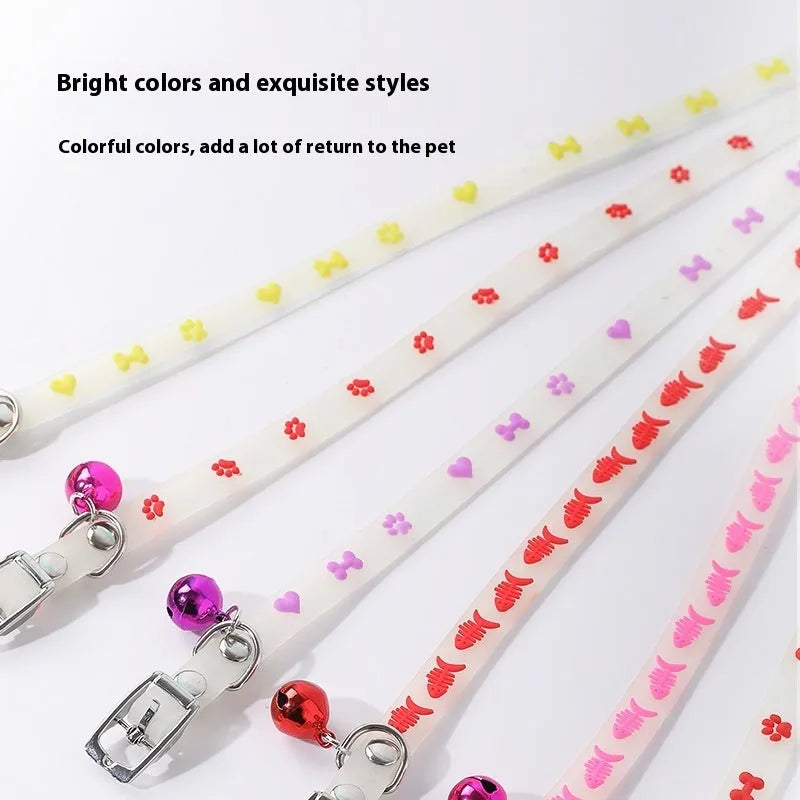 Luminous cat collar with a metal bell on an adjustable 29cm silicone strap, showing paw print design.