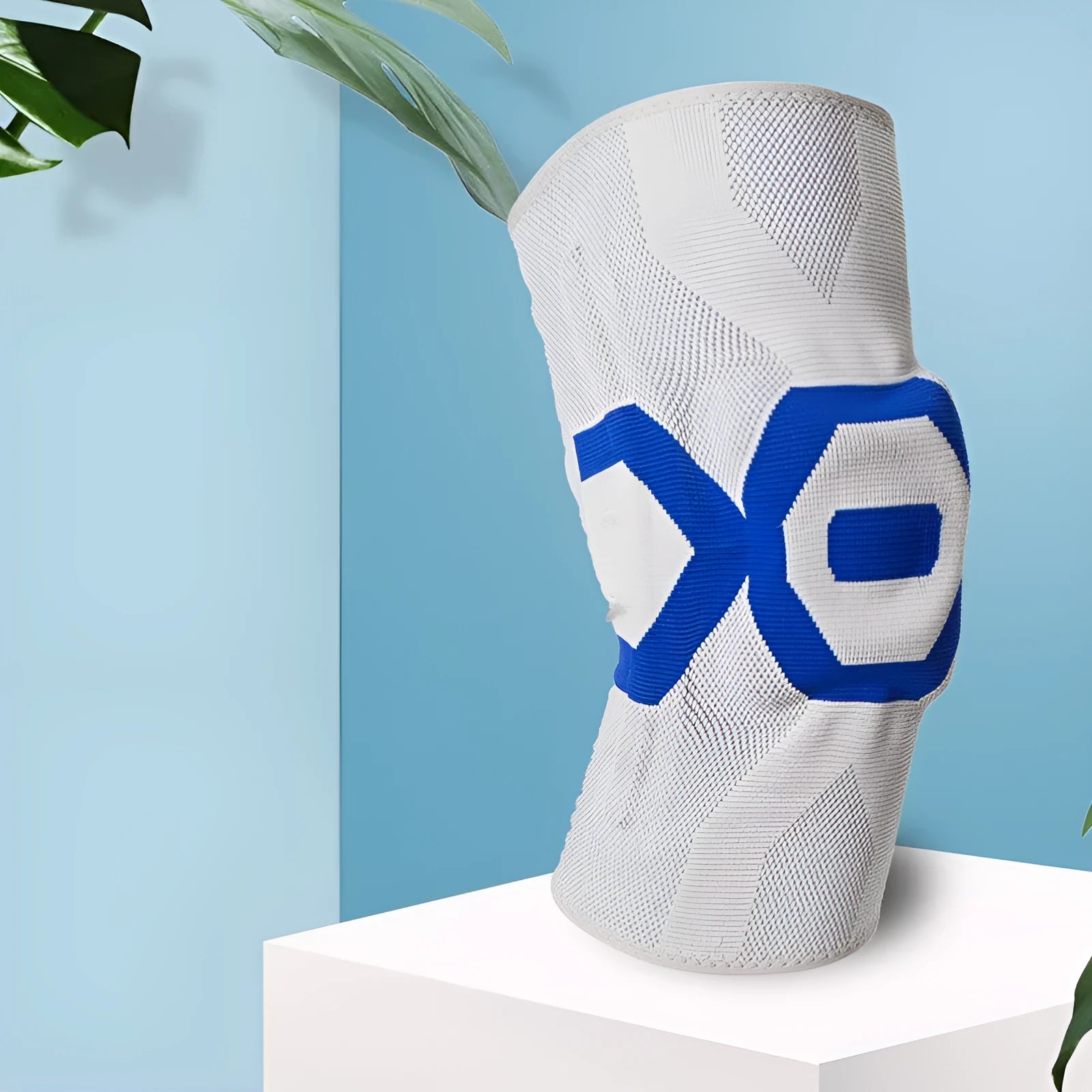 A silicone knee pad for men in a black and blue colour scheme, shown from the side.