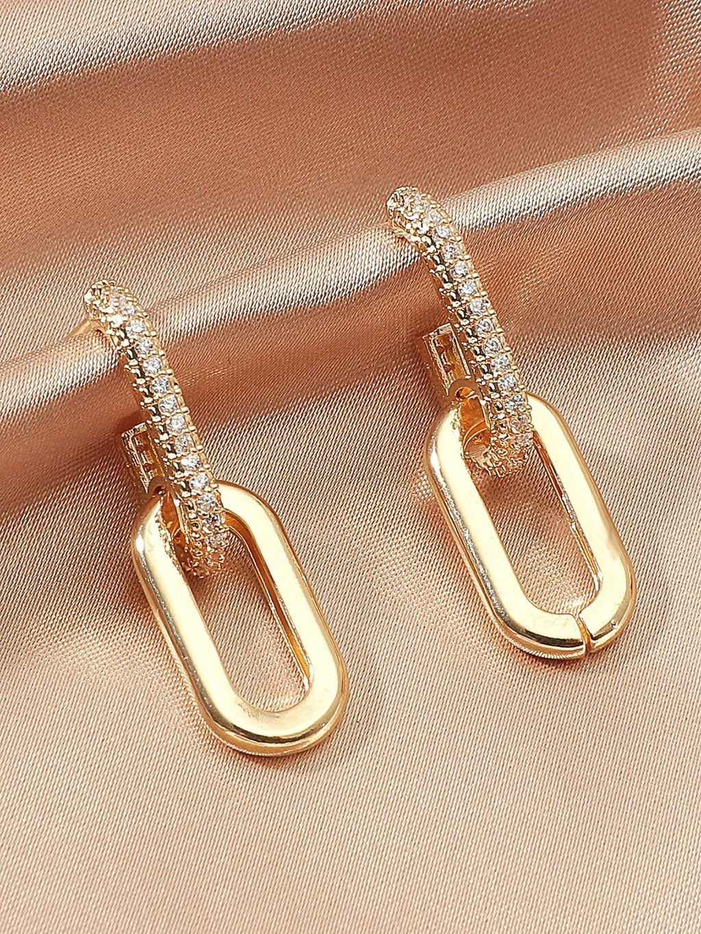 Pair of copper geometric ellipse earrings in 18K gold, silver, and rose gold finishes with diamond treatment