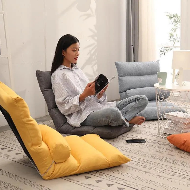 Beige adjustable backrest lazy sofa floor chair folded flat showing fabric texture and reclining mechanism