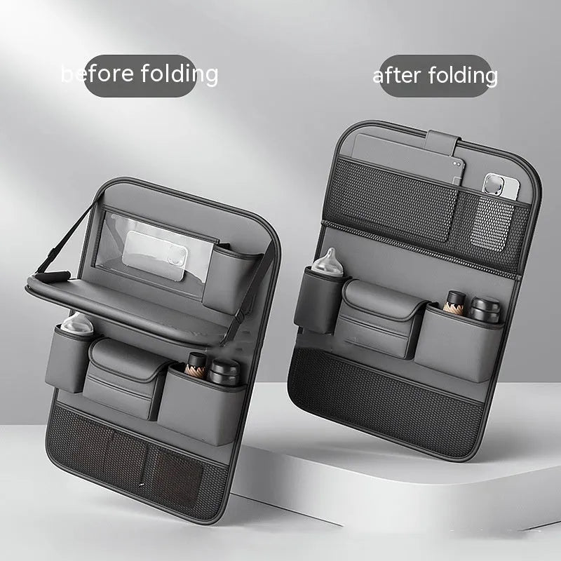 Black leather car seat storage bag with a foldable dining table deployed, hanging behind a car headrest