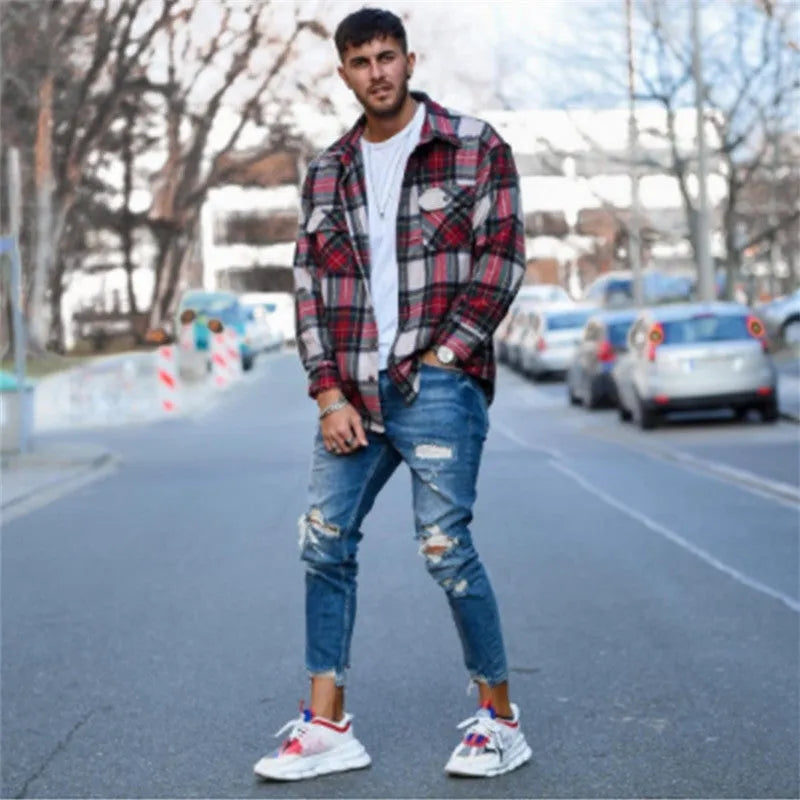 Men's deep blue cotton jeans showing the five-pocket design on a neutral background.