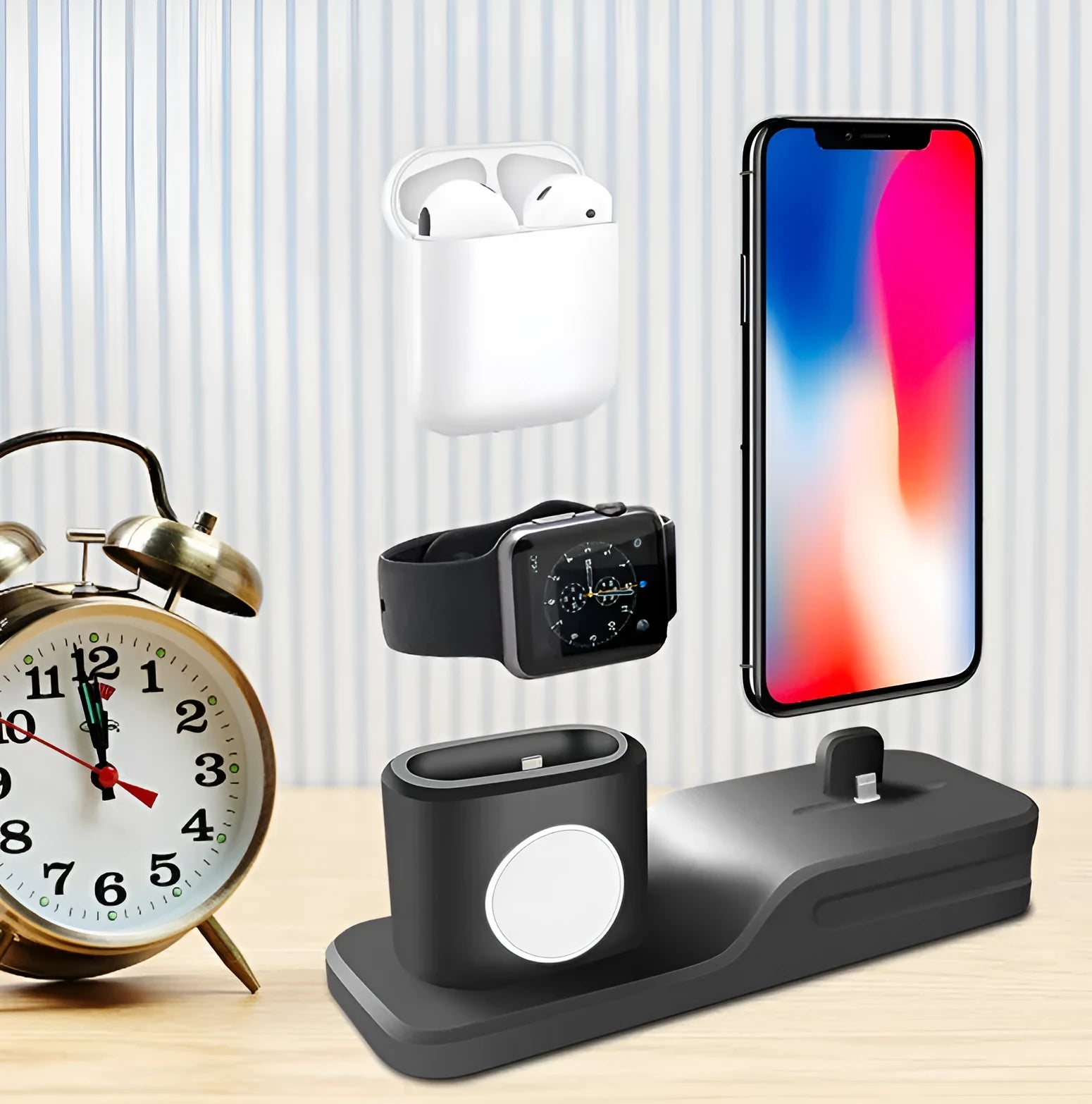 Black silicone 3-in-1 charging stand for iPhone, iWatch, and AirPods on a desk