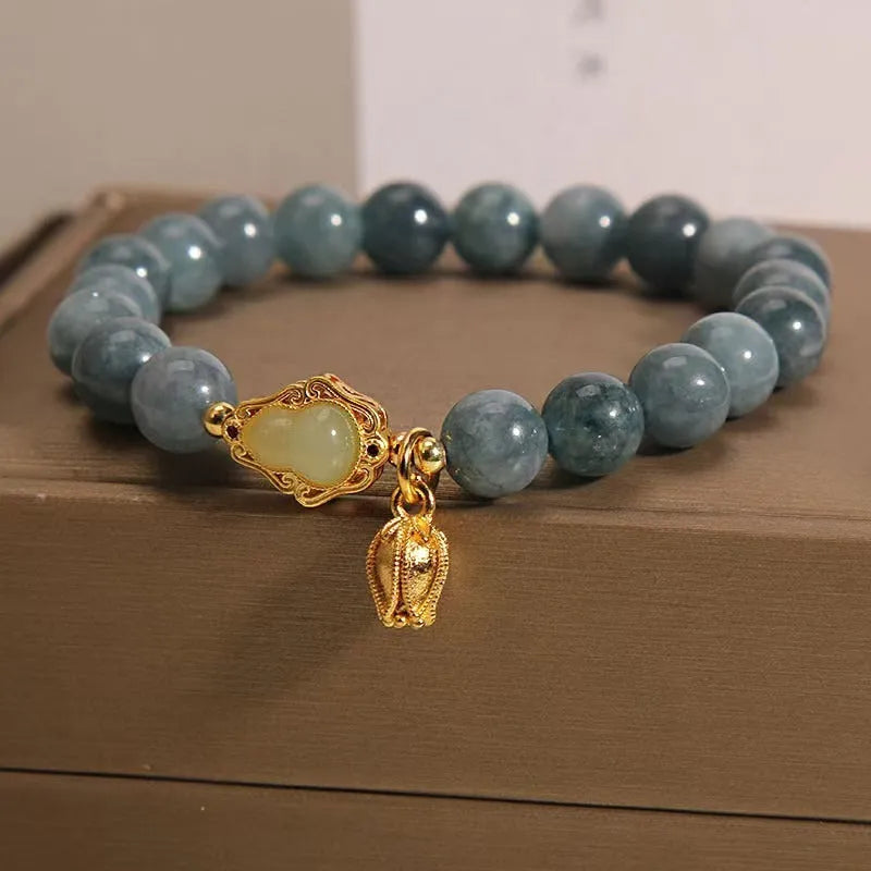 Sky blue natural stone bracelet with carved lotus and gourd pendant on electroplated brass setting