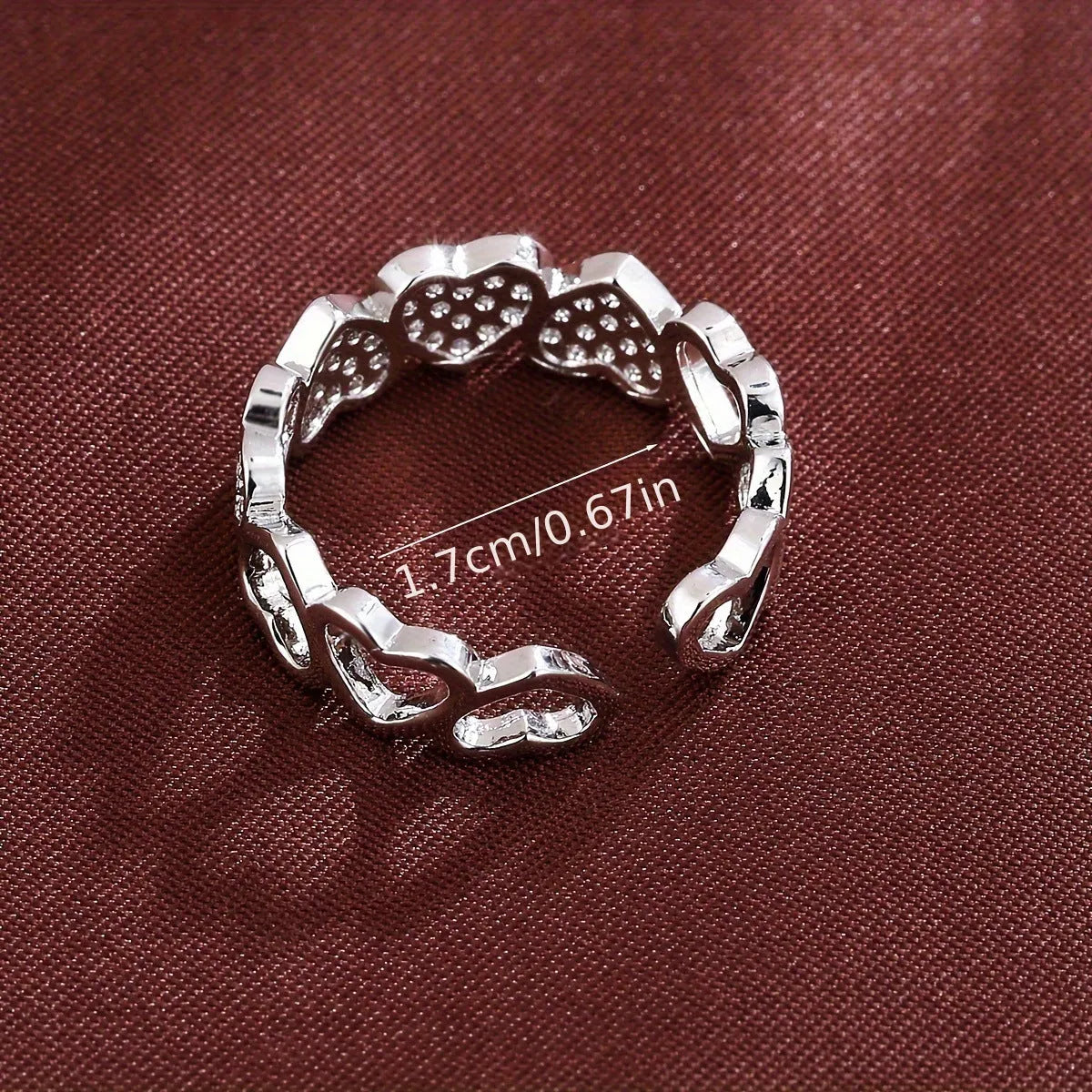 Adjustable geometric couples ring with love heart elements in gold or silver colour, showing opening mechanism