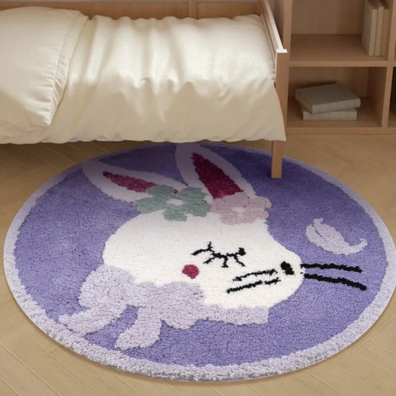 Round light pink polyester floor mat with a cute white rabbit illustration on a wooden floor.
