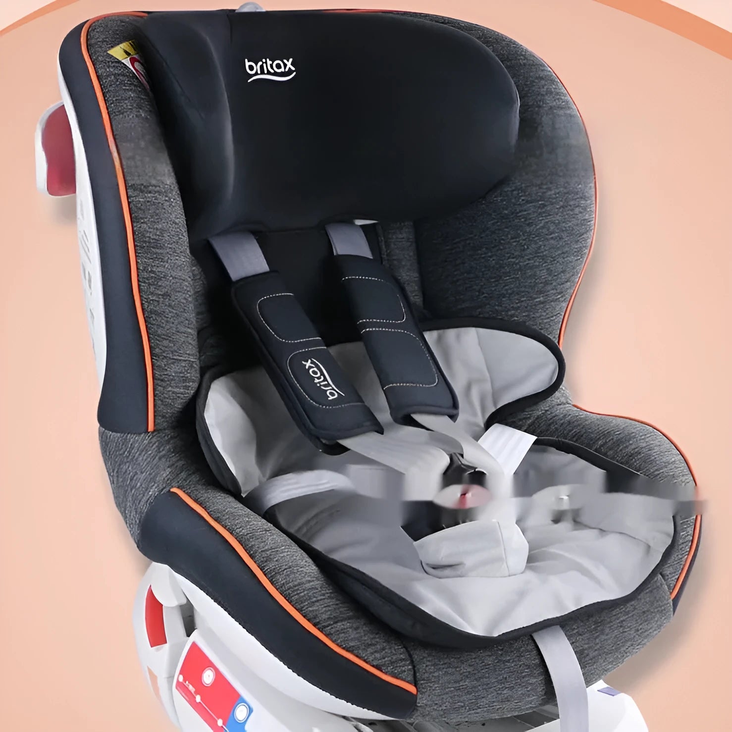 Alien-shaped grey car seat protective pad with urine-separation layer on a car seat.
