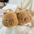 Light brown women's fleece slippers with a cartoon pattern, artificial wool lining, and a PVC sole.