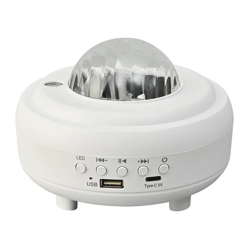 White Galaxy Star Projector on bedside table projecting blue star patterns on wall