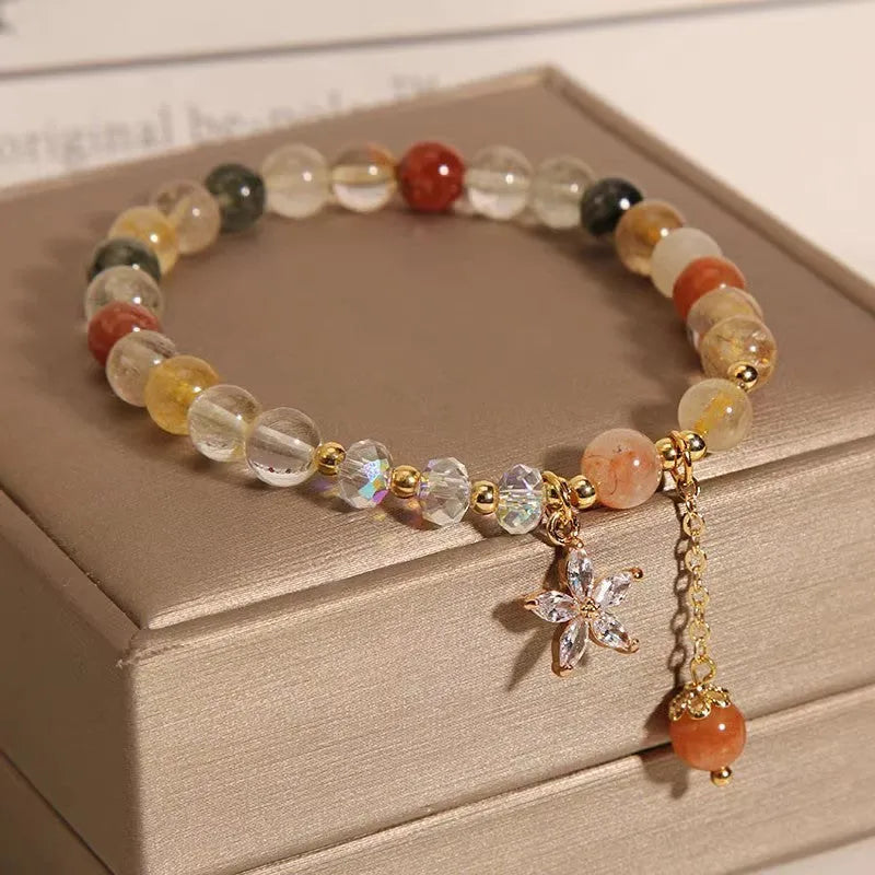 Colour hair crystal cat's paw charm bracelet with zircon butterfly on wrist.