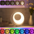 Small RGB colour changing night lamp with remote control on wooden desk