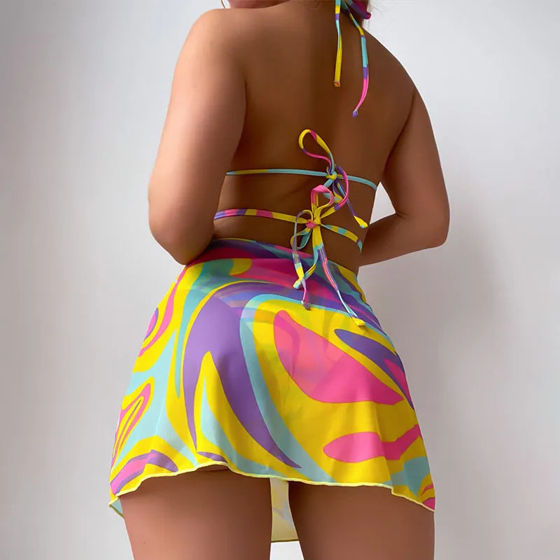 Yellow striped halter-neck swimsuit with lace-up front, matching skirt, and shorts
