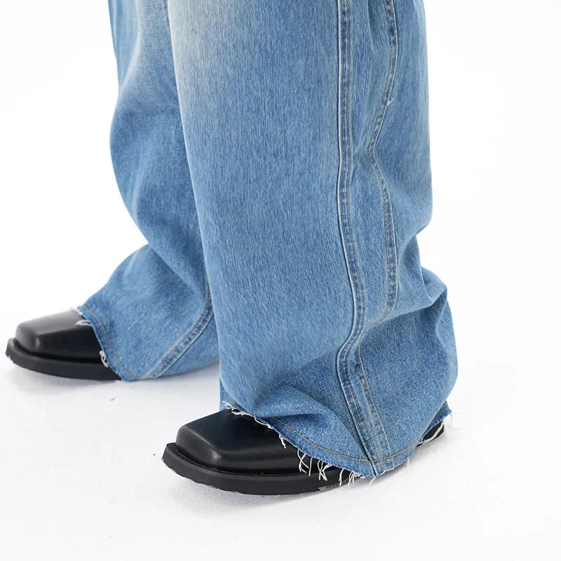 Light blue vintage washed wide leg denim jeans with a zipper fly on a mannequin.