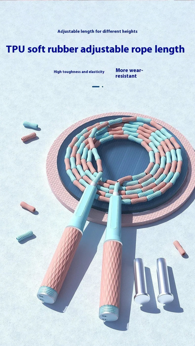 A children's skipping rope with soft bamboo-style beads, shown in a choice of blue, pink, green, and purple colours.