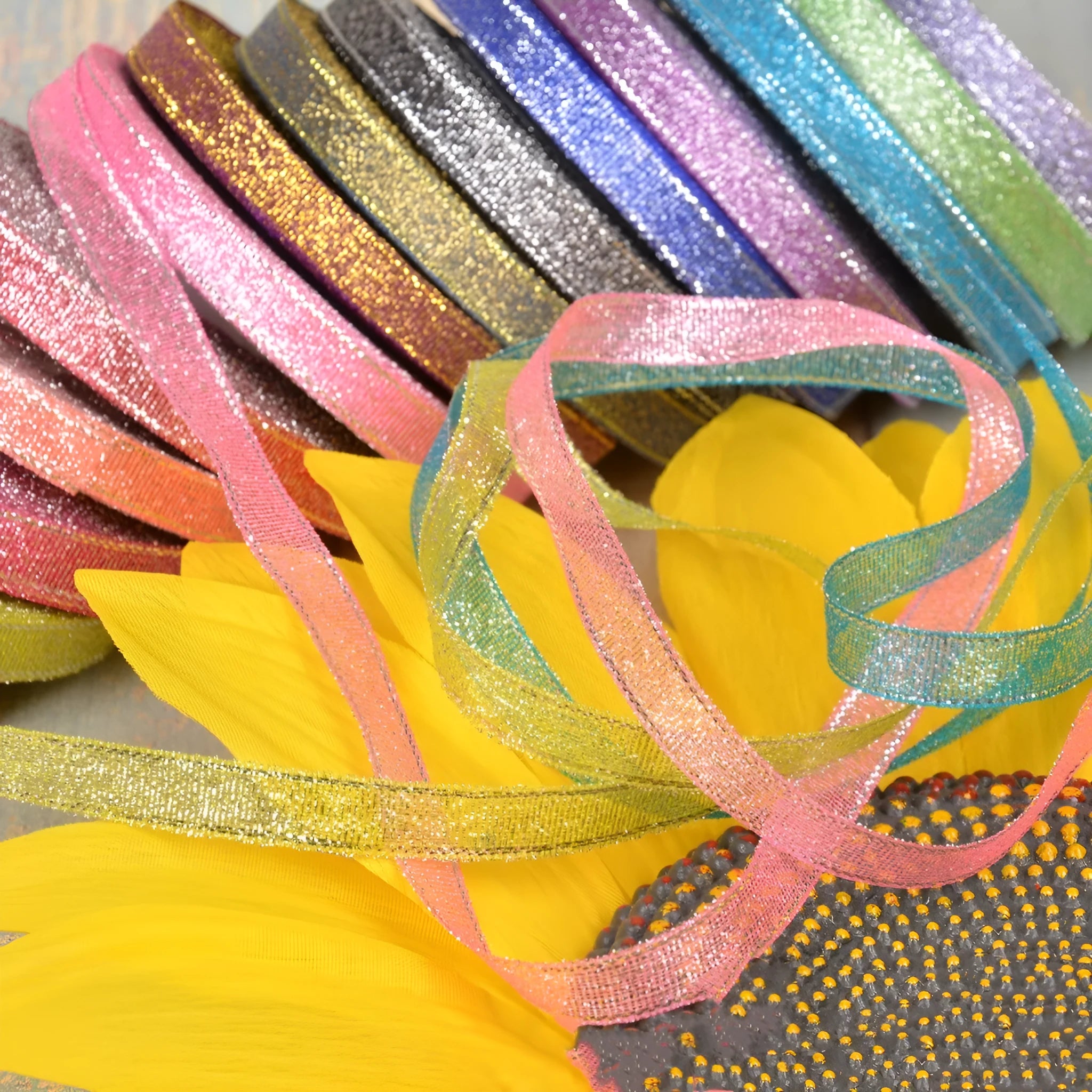 Close-up of green onion patterned polyester ribbon with metallic wire accents on a 25-yard roll.