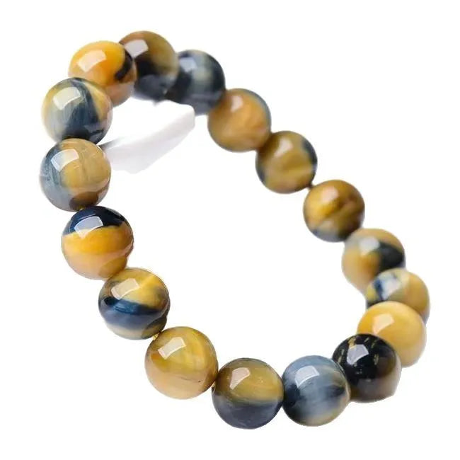 Handmade fantasy tiger eye agate beaded bracelet with 10mm round beads on a wrist.