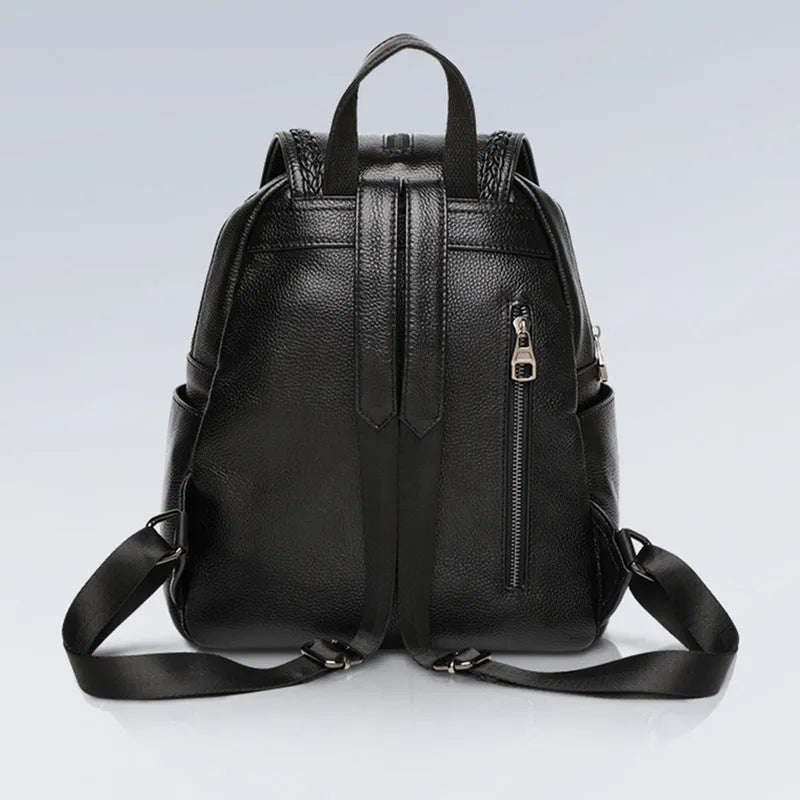 Solid colour genuine leather women's backpack showing blue exterior with multiple compartments and internal organisation