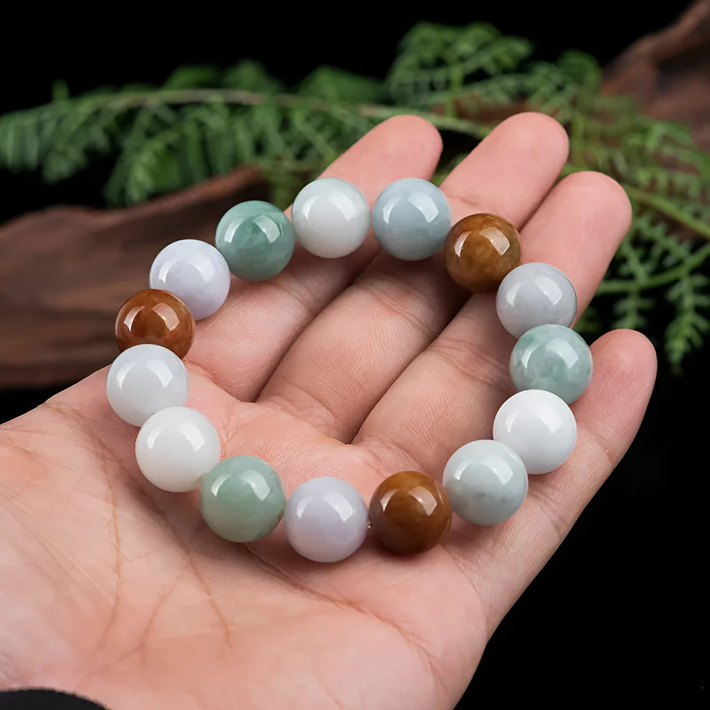 Women's Myanmar jade bracelet with 13mm round beads showing three natural jade colours