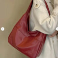 Women's soft PU leather shoulder bag in horizontal square shape showing internal zipper compartment