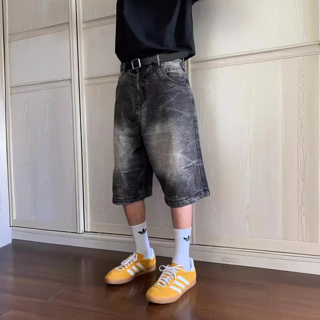 Man wearing loose light blue washed denim cowboy shorts with a straight-leg cut.