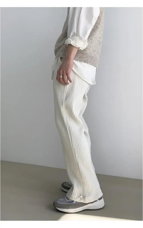 Men's loose corduroy casual pants in solid colour with high waist, drawstring no-fly closure and ankle-tied cuffs.