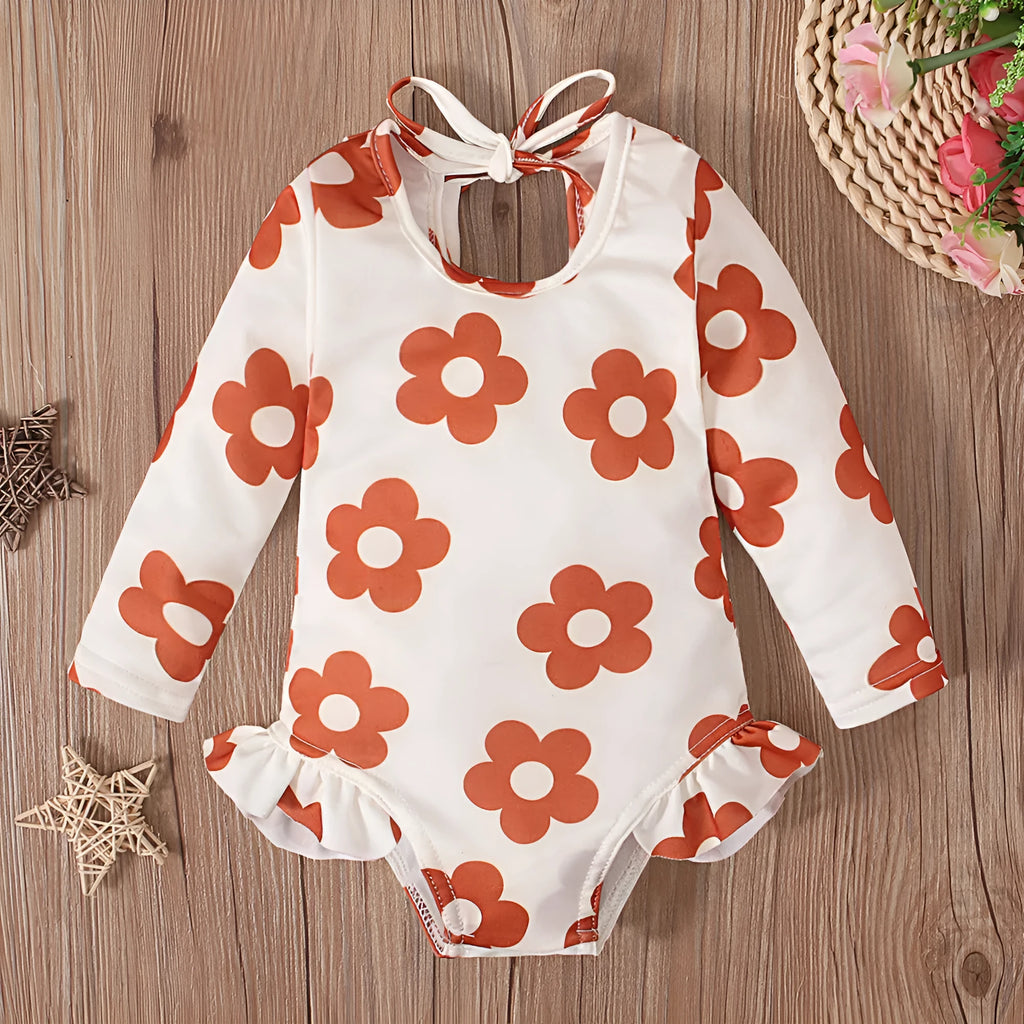 Girl's floral pattern open back swimsuit in polyester fabric showing crew neck design