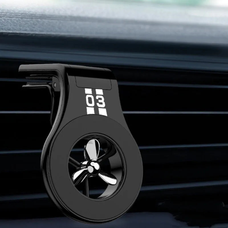 Magnetic car phone holder mounted on air vent with phone attached, showing 360-degree rotation and fragrance slices