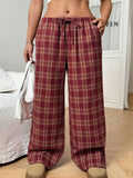 Women's plaid trousers with drawstring waist and pockets in blue and red colours