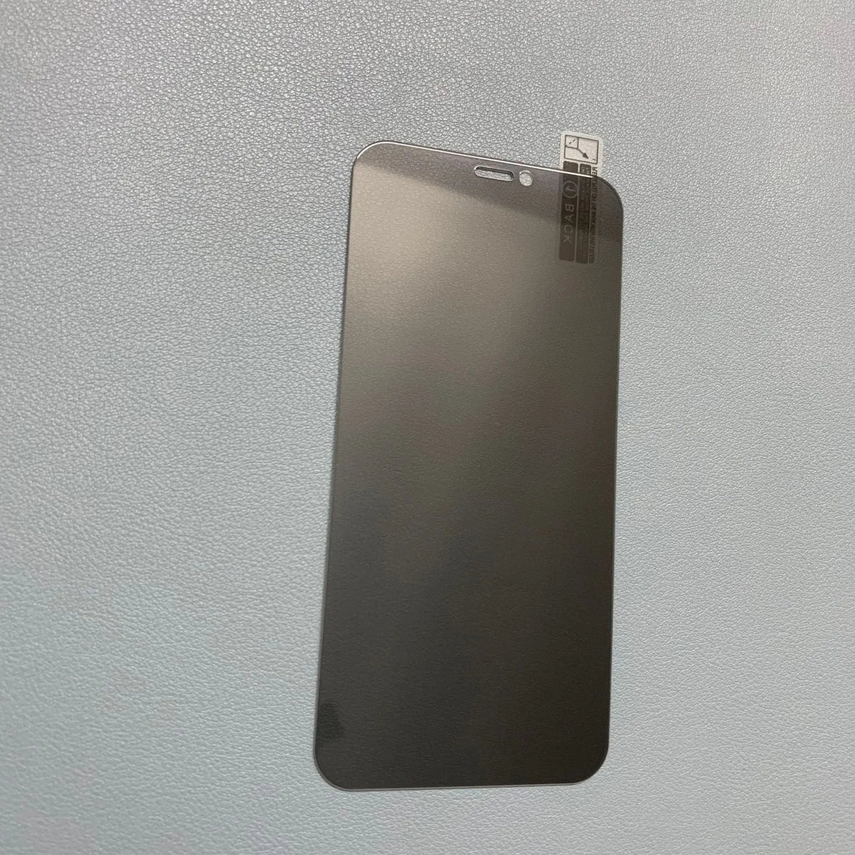 Tempered glass privacy screen protector for iPhone showing narrow viewing angle effect.