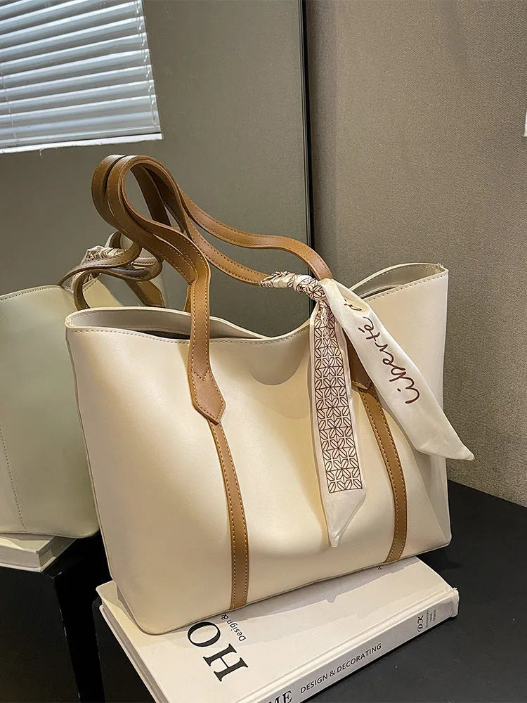 Soft tote bag with crossbody strap showing internal zipper compartment and khaki colour option