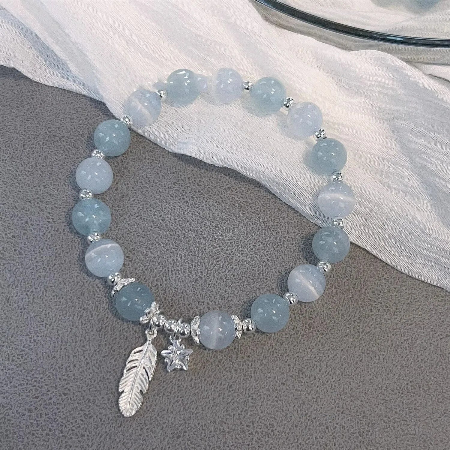 Korean style glass bracelet with feather XINGX blue moonlight colour and eight Awn star decorative elements