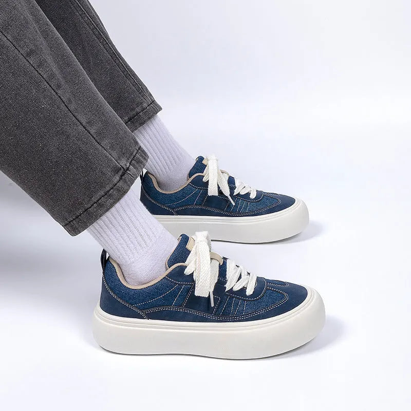 Men's black platform canvas shoes with round toe and lace-up front, showing raised heel design.