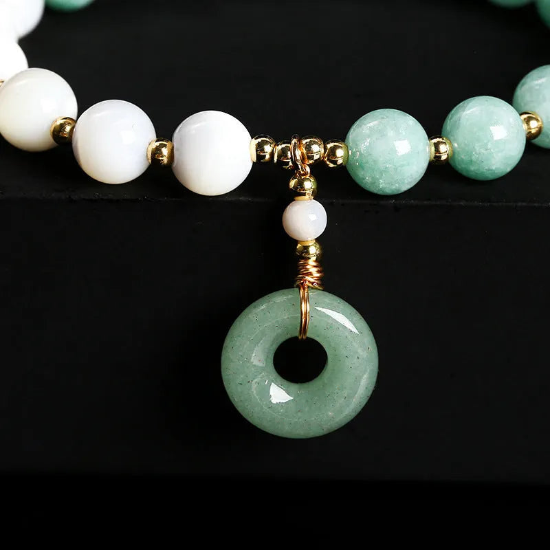Blue Burma jade bracelet with 8mm round beads and a silver safety buckle clasp.