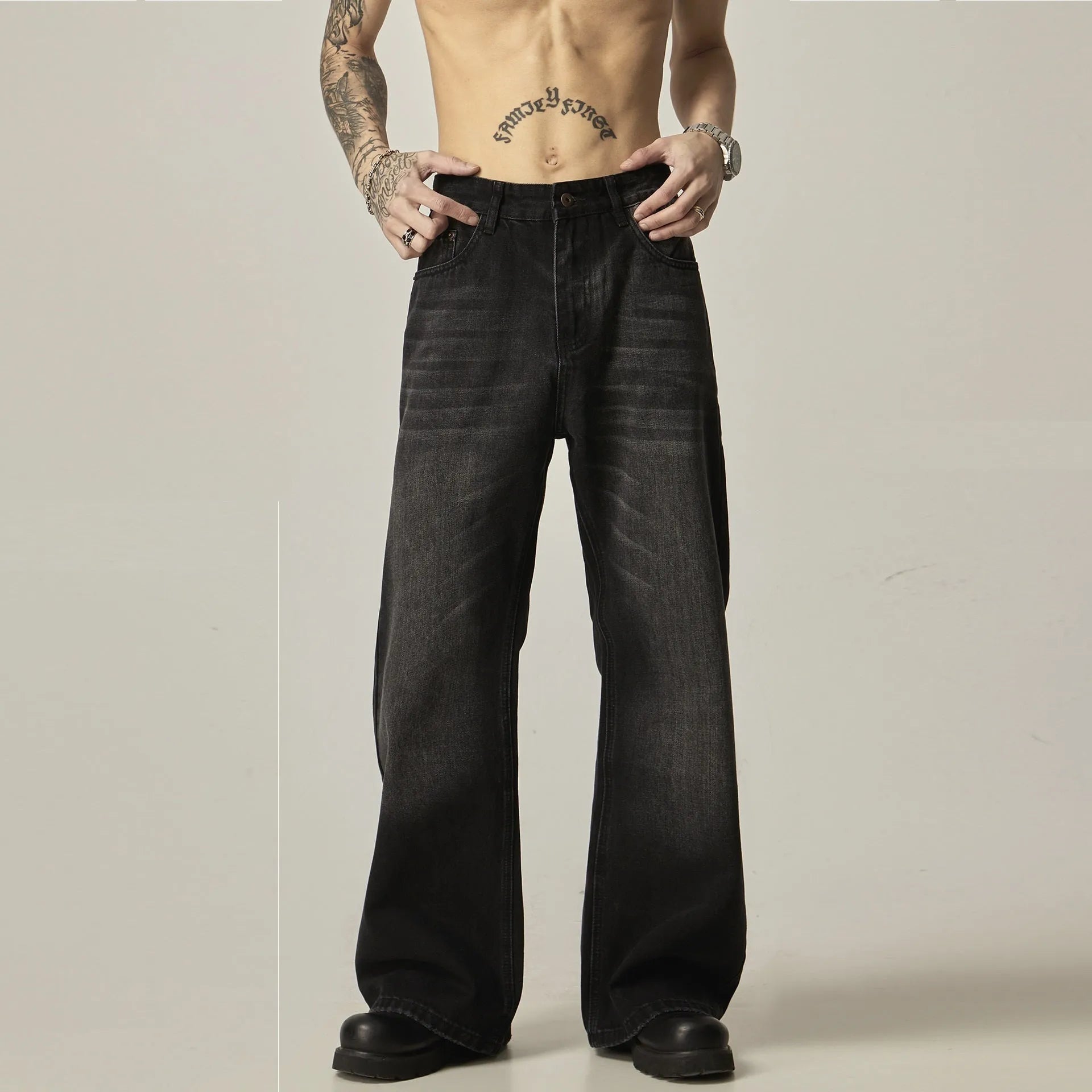 Black loose straight jeans with zipper fly, inelastic denim fabric, retro styling, shown flat and on model