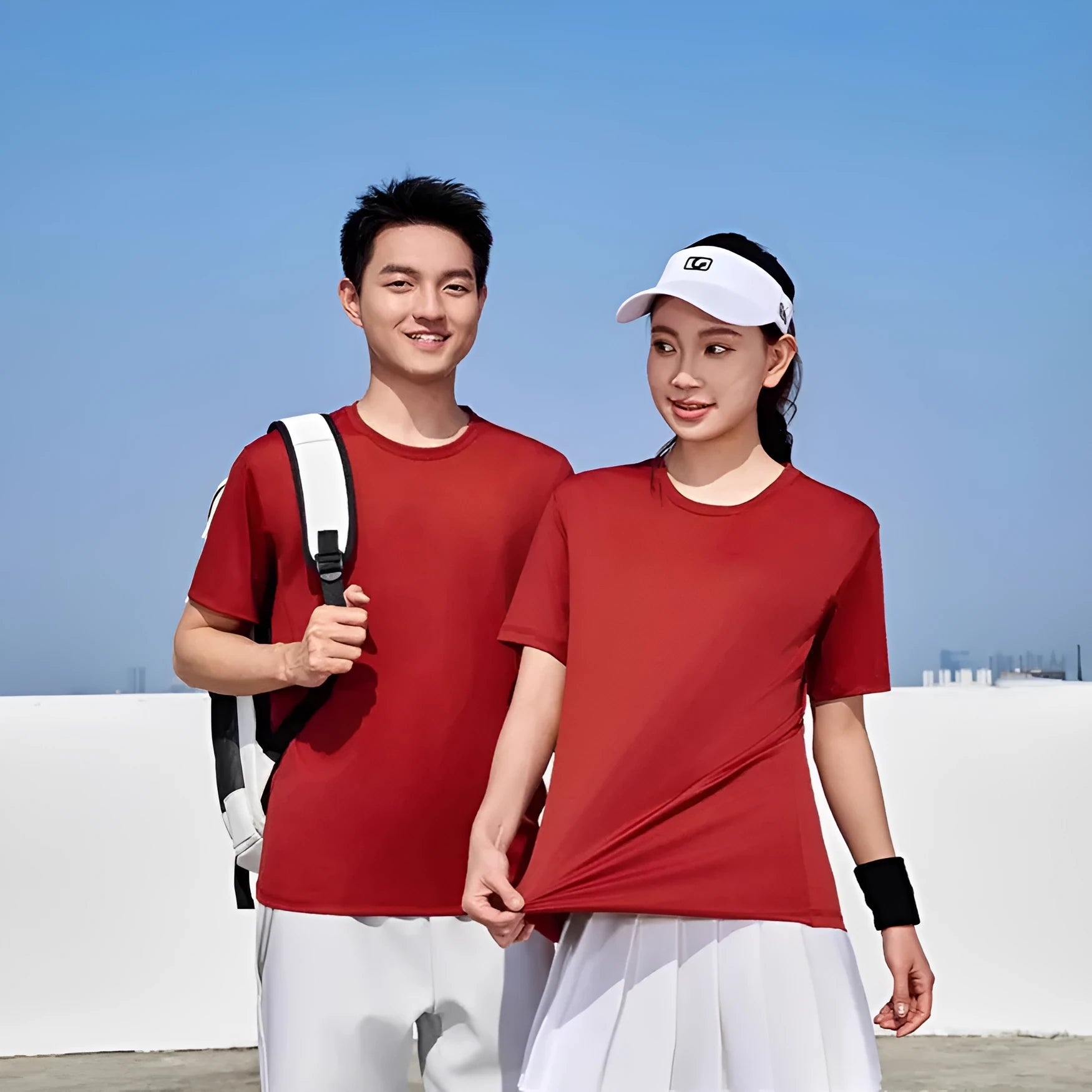 Men's loose fit solid colour polyester sports t-shirt on a hanger, shown in coral pink.