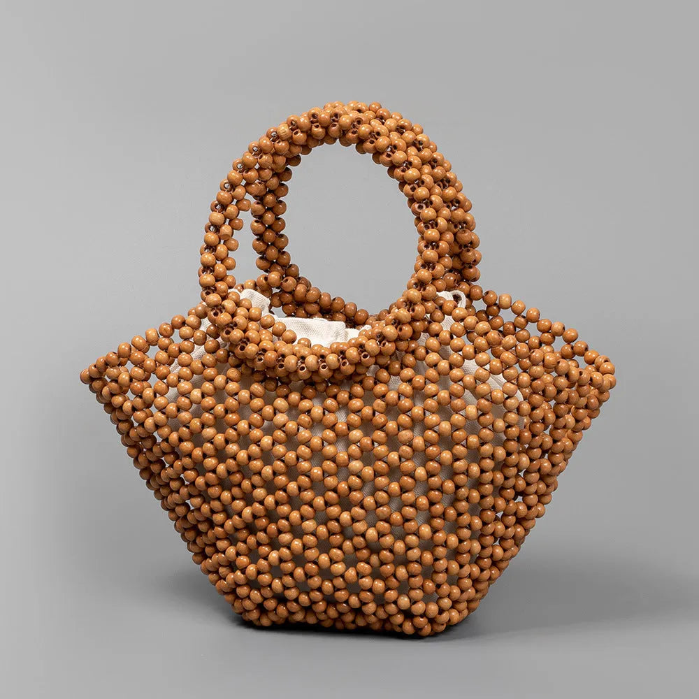 Hand-woven maple wood beach bag with wooden beads in dumpling shape.