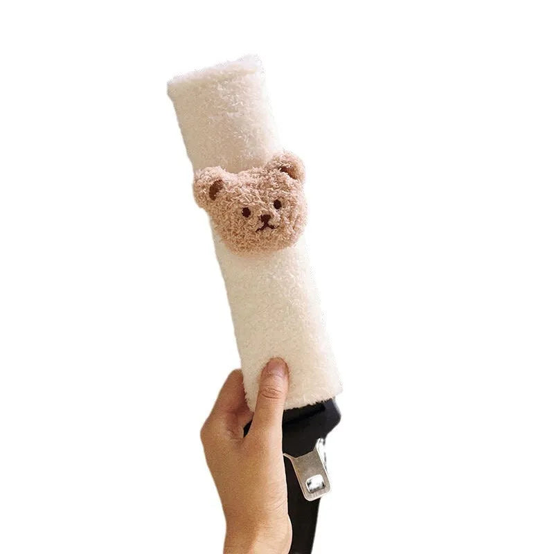 Cartoon bear design plush car seat belt protective cover for infant safety, showing khaki and coffee colour options