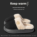 Plush slippers in black with fleece lining and non-slip PVC soles, shown on a wooden floor