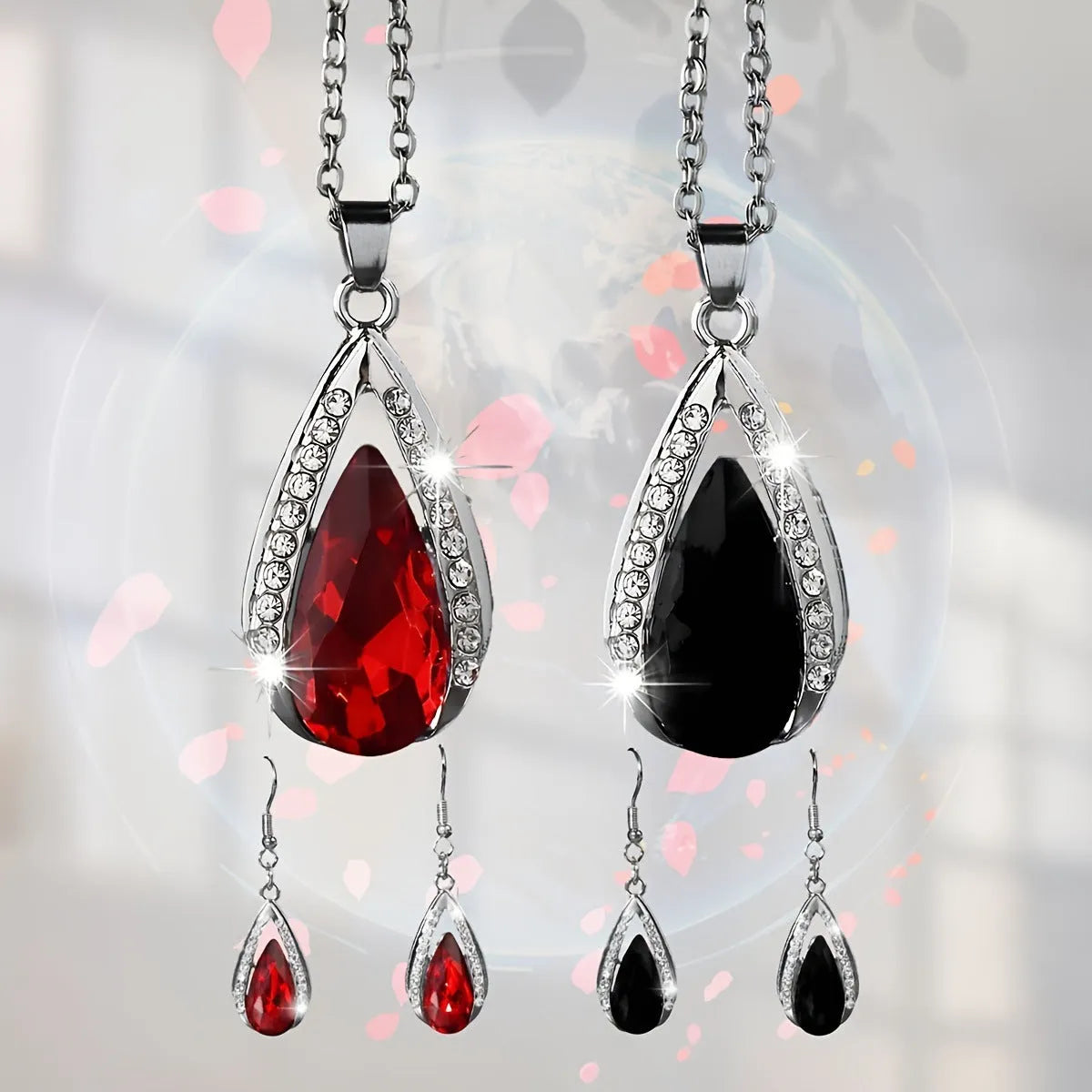 Black and red teardrop glass pendant necklace with matching earrings set on display