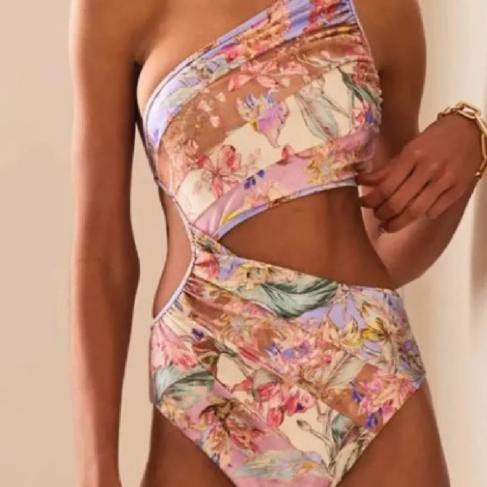 Women's rose gold patterned swimsuit on a hanger.