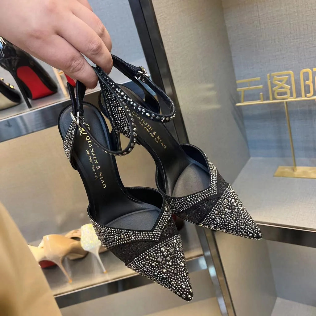 Women's hollow high heels with stiletto heel, pointed toe, and red sole in silver and black colours
