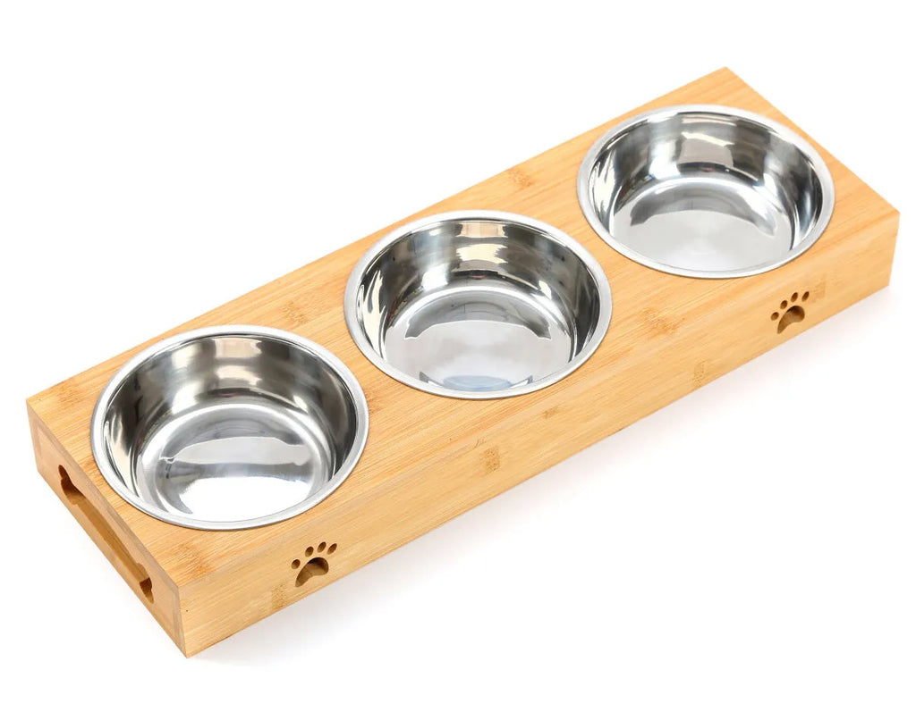 Solid wood pet dining table with stainless steel bowl inserts in a pine finish for dogs and cats.