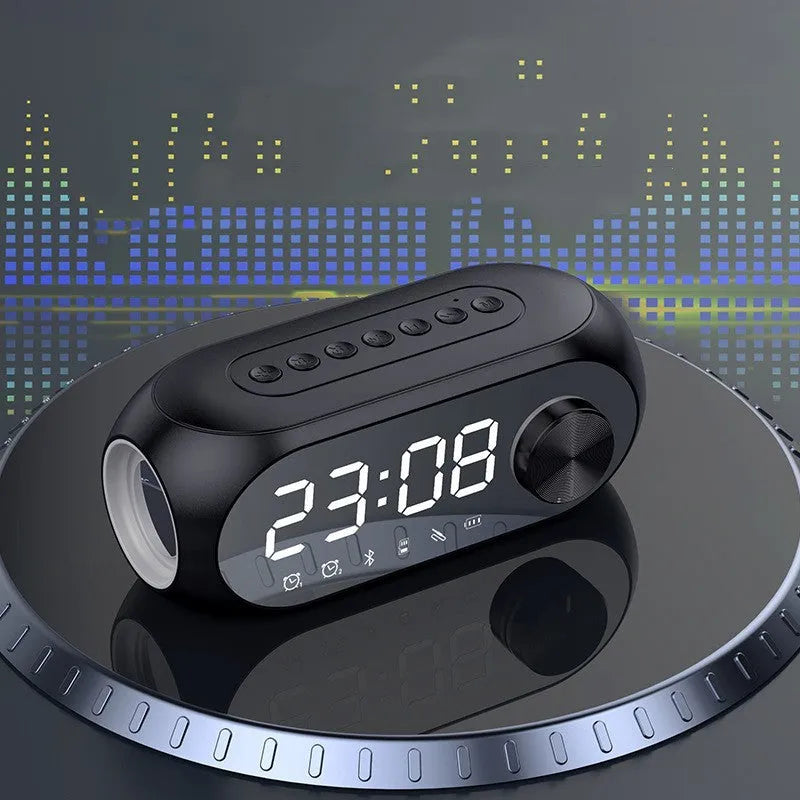 Black portable speaker with digital clock display showing time, USB cable connected, 10cm diameter size
