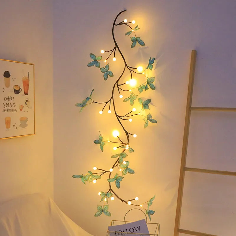 1.8 metre tall flexible rattan tree lamp with colourful LED butterflies, showing bent branches.