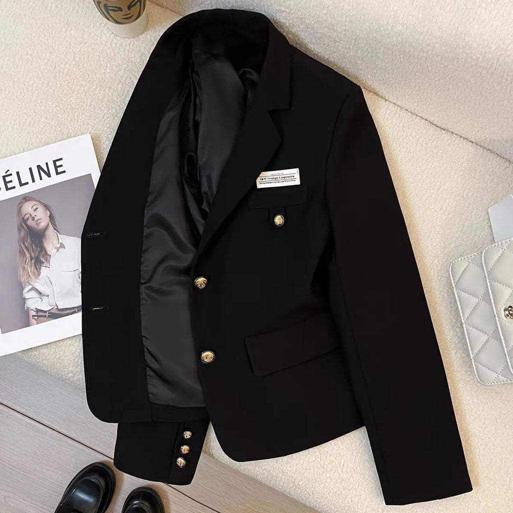 Women's black short suit coat with loose fit, long sleeves, and pocket details, shown in a commuting style.
